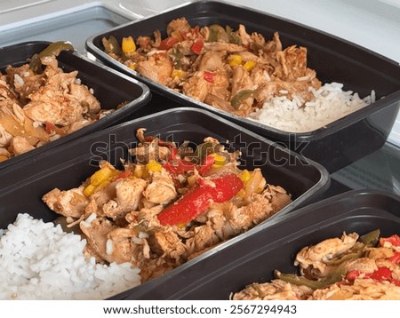 Meal prepping containers with chicken stir fry and rice 