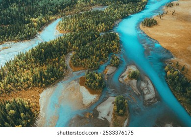 Meandering river with vibrant blue waters and lush green forested banks, creating a vivid contrast between flowing water and dense foliage. - Powered by Shutterstock