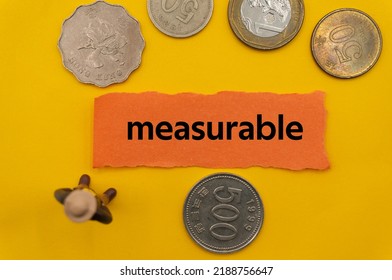 measurable.The word is written on a slip of paper,on colored background. professional terms of finance, business words, economic phrases. concept of economy.