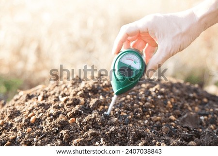 measure the acidity of the field using a soil pH meter