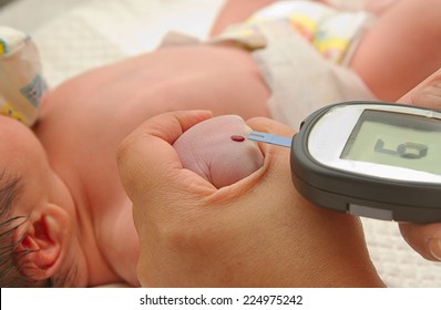 Measure Child Glucose Level Blood Test Diabetes New Born Baby  Using Glucometer