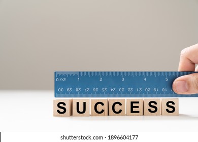 Measure Success Word Using Blue Ruler, Representing A Review, Evaluation Or Assessment Of An Employee