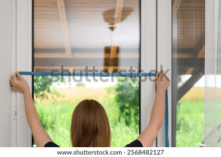 Measure the width of the window with the frame using a tape measure