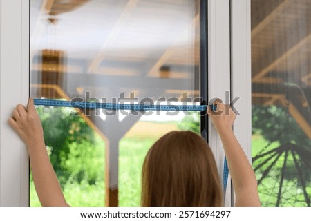 Measure the width of the window from frame to frame using a tailor's tape measure for custom-made blinds