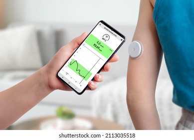 Measurement Of Blood Glucose With The Help Of Mobile App And Sensor. Hand Brings The Phone Closer To The Sensor Located On The Child's Hand Concept 