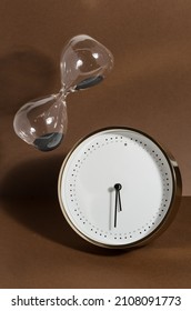 The Measurement And Perception Of Time.  Hourglass And Clock Still Life.