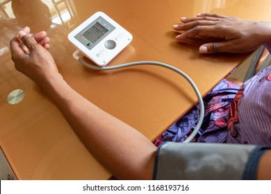 Measurement Of Pressure. Black African American Woman Takes Care Of Her Health By Checking Her Blood Pressure And Pulse On Her Arm With BP Apparatus