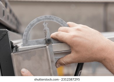 Measuring angle on aluminium profiles with angle meter. It is showing a little less than 90 degrees. - Powered by Shutterstock