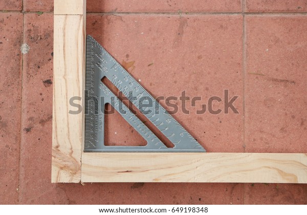 Measuring\
angle of wooden structure for making\
furniture