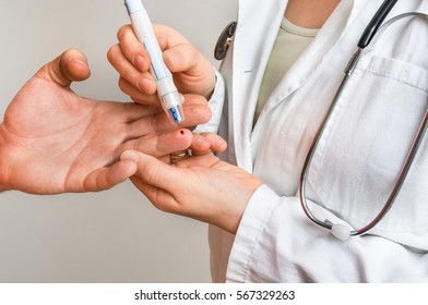 Measuring Blood Sugar On Finger - Diabetes And Glicemia Concept