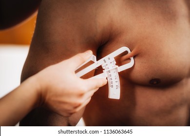 Measuring Body Fat On Chest Using Skinfold Thickness (caliper) On Male Athlete.  