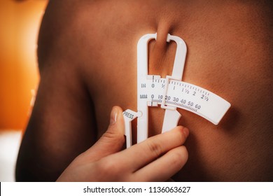 Measuring Body Fat On Subscapular Using Skinfold Thickness (caliper) On Male Athlete.  