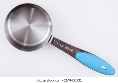 Measuring Cups and Spoons, on a white background. 1⁄3 cup 80mL.