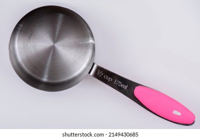 Measuring Cups and Spoons, on a white background. 1⁄2 cup 125mL.