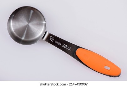 Measuring Cups and Spoons, on a white background. 1⁄8 cup 30mL.