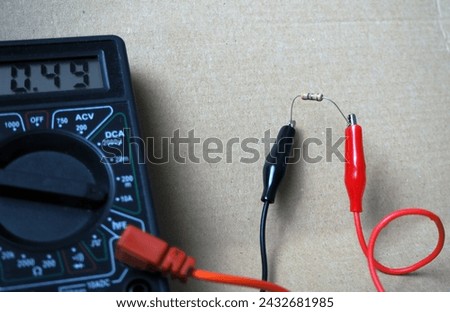 Measuring electric current through a resistor with an ammetter. 490 milliamperes of current flows through the resistor.Focused on resistor. 
