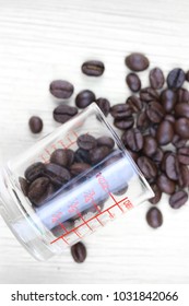 Measuring Medicine Cup And Coffee Beans 