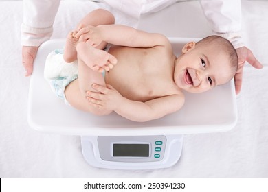 Measuring smiling beautiful comfortable little baby child