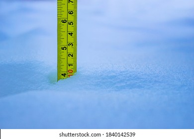 Measuring The Snow Depth With Yellow Ruler 10 Centimeters