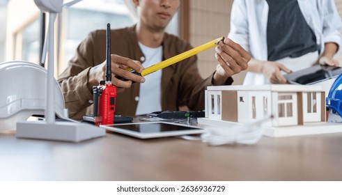 Measuring for Sustainability. Architect using tools for eco-friendly building design.