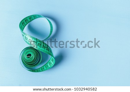 Measuring tape in the form of eight on a blue background