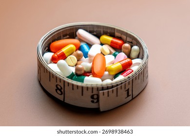 A measuring tape forms a circular container filled with a variety of colorful pills and capsules. Diet pills, weight loss supplements, and medical dosage control concepts.