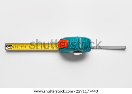 Measuring tape on grey background
