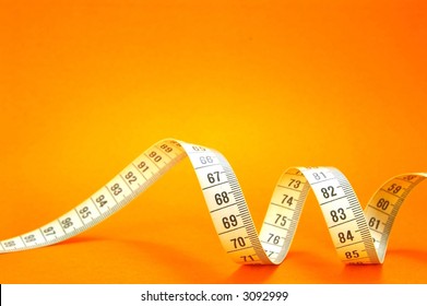 Measuring Tape On Orange Background - Powered by Shutterstock