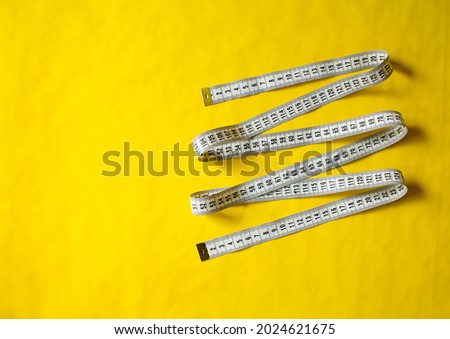 measuring tape on a yellow background. centimetre