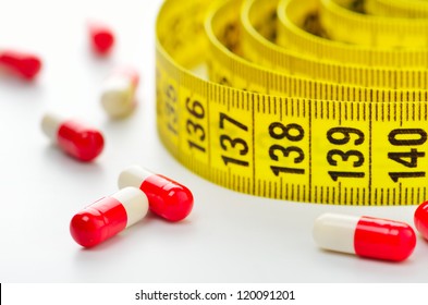 Measuring tape and pills for dieting concept