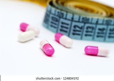 Measuring tape and pills for dieting concept