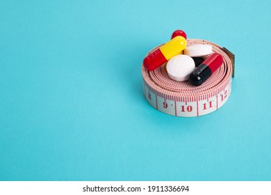 Measuring Tape And Pills For Dieting Concept. EKG Medical Health Care And Prevention.