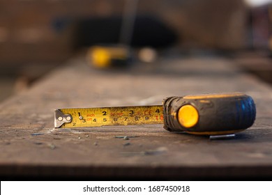 Measuring Tape Placed on a steel floor