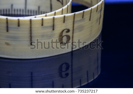 measuring tape with reflection on black background