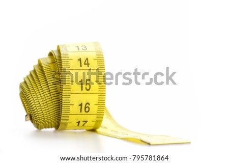 Measuring tape of tailor with indicators in form of centimeters. Yellow rolled measuring tape isolated on white background. Handicraft and tailoring concept. Rolled centimeter ruler of yellow color.