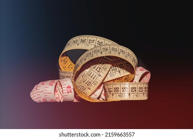 Measuring tape for tailor, selective focusing. Tailor's tools on a black background. Still life with tailor's objects isolated on a black background. Sewing centimeter, centimeter tape.