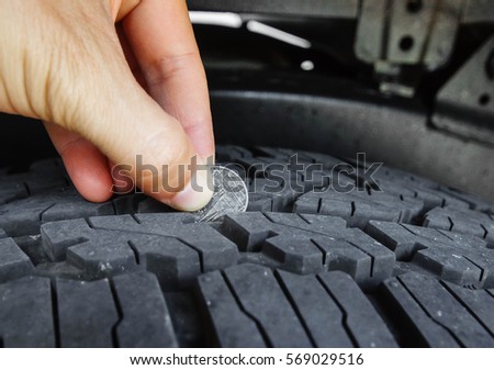 Measuring tire depth using a small coin