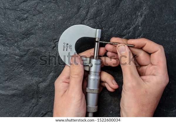 Measuring tool. Vernier caliper on black stone.\
Background, texture.\
Close-up