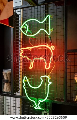 Meat animals emblems. Retro advertisement of fast food restaurant or butcher shop. Neon sign of restaurant dishes - fish, pork, chicken.