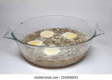 Meat Aspic With Halved Eggs, Frozen Bone Broth Jelly With Pieces Of Boiled Meat In Glass Round Casserole Dish With Handles