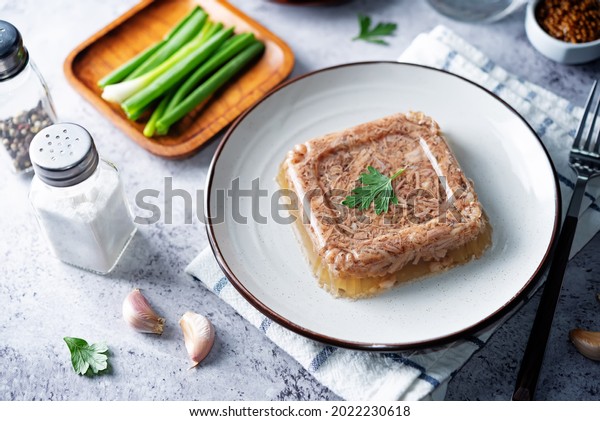 Meat aspic in a plate with mustard. toning.\
selective focus