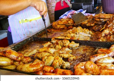Meat is being cooked for asado at Mercado Cuatro in Asuncion, Paraguay. Asado is a traditional dish in Paraguay and usually consists of beef alongside various other meats, which are cooked on a grill