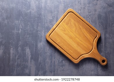 Meat or bread cutting board for homemade baking on table. Food recipe concept at stone background texture with copy space. Flat lay top view