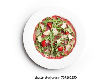 Meat Carpaccio with Rocket Salad, cherry tomato and Parmesan Cheese on white background - Powered by Shutterstock