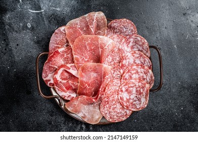 Meat Charcuterie Plate with Prosciutto crudo, Salami and Coppa Sausage. Black background. Top view. - Powered by Shutterstock