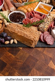 A Meat Cheese And Fruit Charcuterie Board On A Wooden Butcher Block