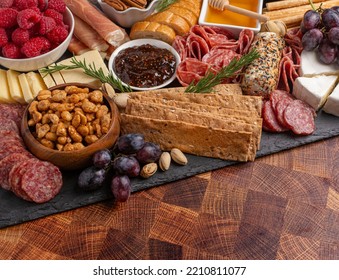 A Meat Cheese And Fruit Charcuterie Board On A Wooden Butcher Block