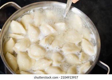 Meat Dumplings In Boiling Water. Meat Dumplings Are Boiled In A Pot Of Boiling Water. Home Fast Food