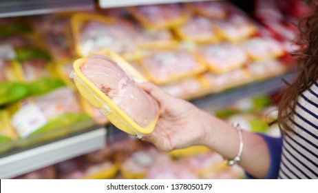 Meat In Food Store . Woman Choosing Packed Fresh Chicken Meat In Supermarket .