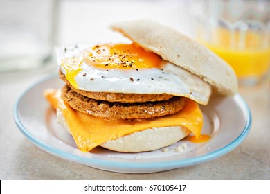 Meat Free Sausage Flavour Patties With Cheese And Egg On Breakfast Muffin 